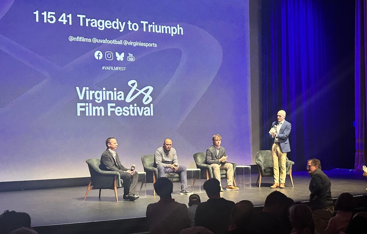 Greg Frith (far left), Tony Elliott (center left) and Will Bettridge (center right) receive a standing ovation after Sunday's screening.