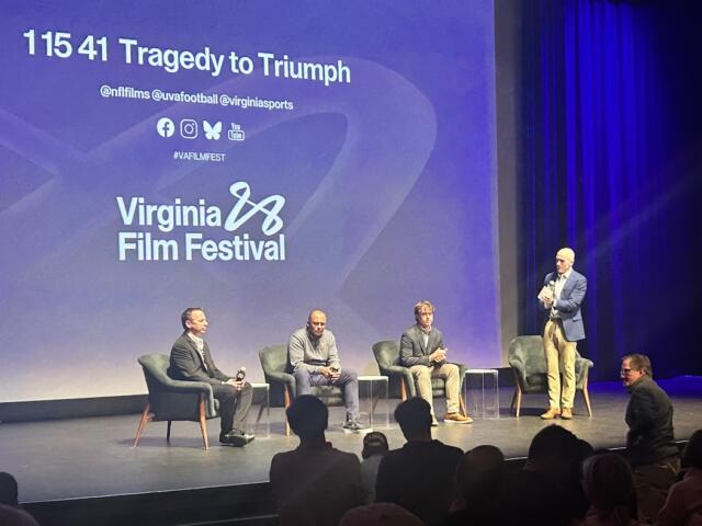 Greg Frith (far left), Tony Elliott (center left) and Will Bettridge (center right) receive a standing ovation after Sunday's screening.