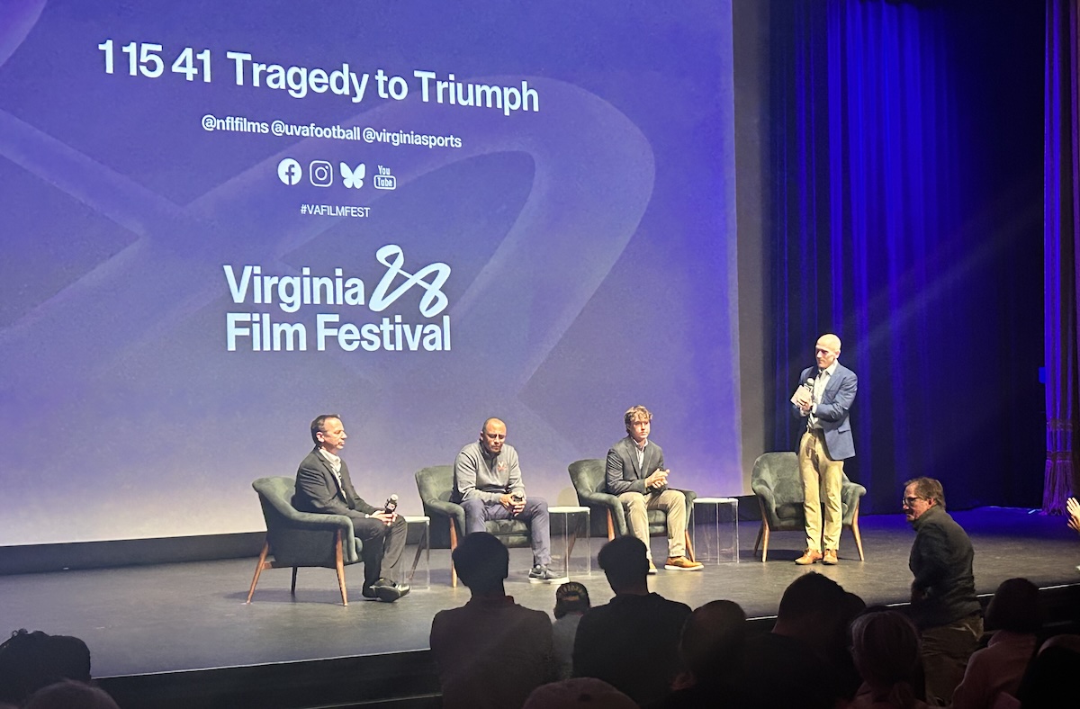 Greg Frith (far left), Tony Elliott (center left) and Will Bettridge (center right) receive a standing ovation after Sunday's screening.