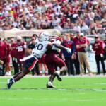 UVA's Omillio Agard tackles Ousmane Kromah.