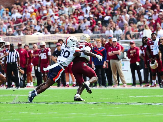 UVA's Omillio Agard tackles Ousmane Kromah.
